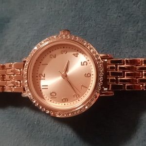 Ladies Fmd Rose gold tone basket weave band stainless steel bezel watch.